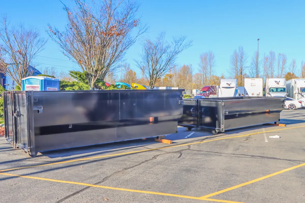 Professional dumpster rental service with roll-off container on residential driveway in Diamondhead